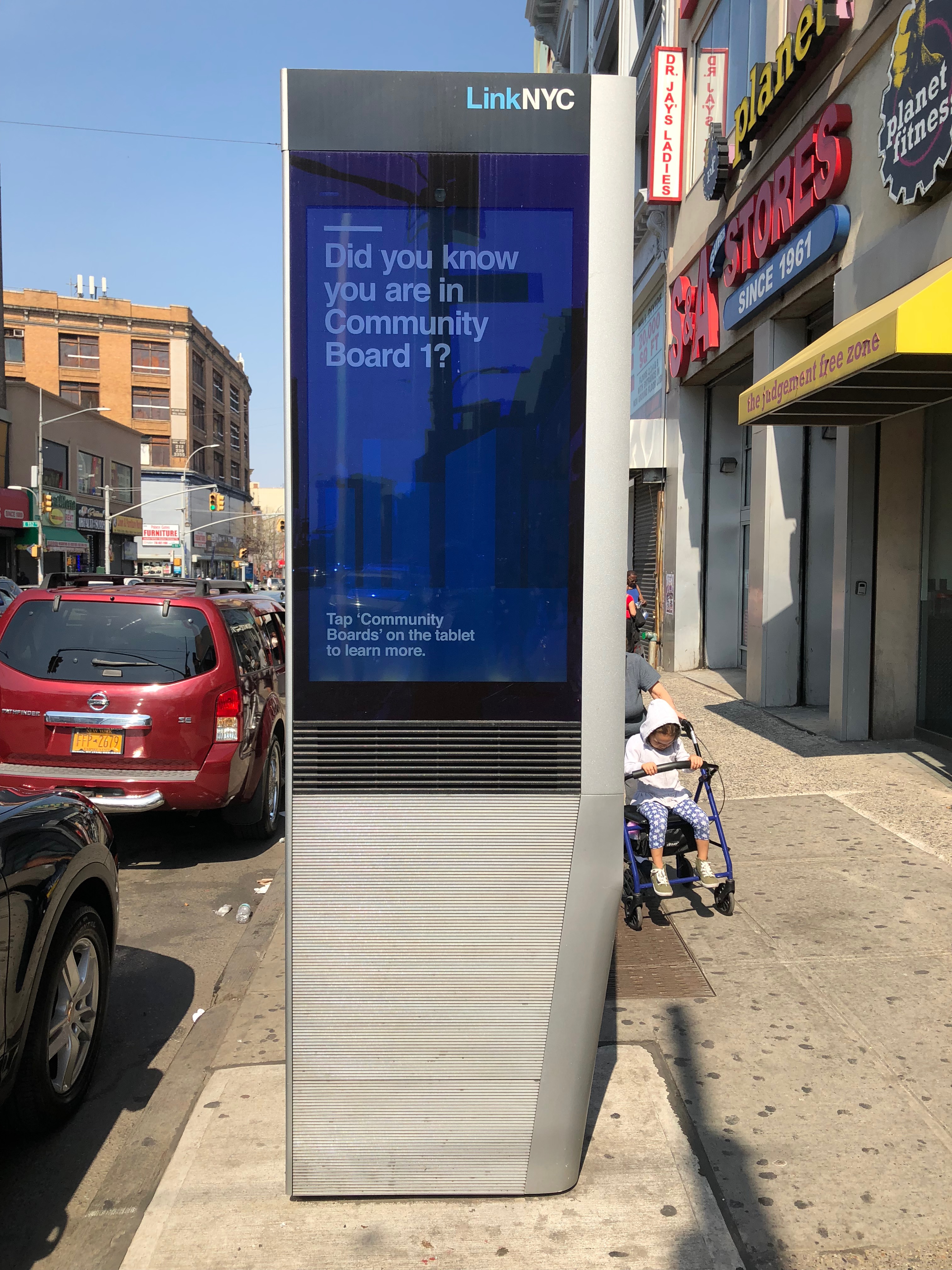 LinkNYC kiosk on 3rd Avenue in the Bronx displaying a Community Board 1 advertisement